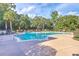 Large, serene community pool with multiple seating areas and lush tropical landscaping at 200 River Landing Dr # 307B, Charleston, SC 29492