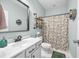 Modern bathroom with a stylish mirror, patterned shower curtain, and a toilet at 201 Maywood Dr, Moncks Corner, SC 29461
