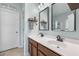 Bathroom vanity with double sinks, framed mirrors, and decorative shelf at 201 Maywood Dr, Moncks Corner, SC 29461