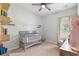 Adorable Bedroom with grey baby furniture and a cozy chair near the window at 201 Maywood Dr, Moncks Corner, SC 29461