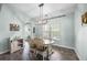 Bright dining room with modern chandelier, wood table and chairs, and lots of natural light at 201 Maywood Dr, Moncks Corner, SC 29461