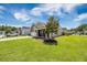 Lovely exterior view of brick home with green grass and a driveway leading to a two-car garage at 201 Maywood Dr, Moncks Corner, SC 29461