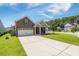 Beautiful brick home with a manicured lawn, long driveway, and an attached two car garage at 201 Maywood Dr, Moncks Corner, SC 29461