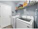 Functional laundry room with modern washer and dryer, and storage space at 201 Maywood Dr, Moncks Corner, SC 29461