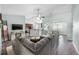 Open-concept living room with a large sectional sofa and connected dining and kitchen areas at 201 Maywood Dr, Moncks Corner, SC 29461
