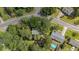 Overhead view of houses nestled among lush trees, showcasing a pool and neighborhood layout at 202 Woodbridge Dr, Summerville, SC 29486