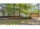 Lush backyard with an outdoor grill station and inviting pond features and wooden deck at 202 Woodbridge Dr, Summerville, SC 29486