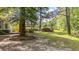 Expansive backyard showcasing a patio, grill area, storage shed and lush greenery at 202 Woodbridge Dr, Summerville, SC 29486