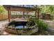 Beautiful backyard pond with rock accents and a wooden pergola with an outdoor kitchen at 202 Woodbridge Dr, Summerville, SC 29486