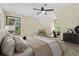 Comfortable bedroom featuring a ceiling fan, neutral walls, and a bright window view at 202 Woodbridge Dr, Summerville, SC 29486