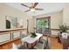 Dining room features wood floor, panel molding, and a ceiling fan at 202 Woodbridge Dr, Summerville, SC 29486