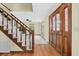 Bright foyer featuring hardwood floors, staircase, and stained glass door at 202 Woodbridge Dr, Summerville, SC 29486