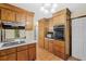 Kitchen featuring wooden cabinets, tile flooring, built-in microwave, and an oven at 202 Woodbridge Dr, Summerville, SC 29486