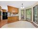 Cozy kitchen with breakfast bar, eat-in area with large windows, and tile flooring at 202 Woodbridge Dr, Summerville, SC 29486