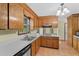 Bright kitchen featuring wooden cabinets, tile flooring, white countertops, and stainless steel sink at 202 Woodbridge Dr, Summerville, SC 29486