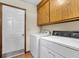 Laundry room with appliances, overhead cabinets, and tile flooring at 202 Woodbridge Dr, Summerville, SC 29486