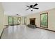 Bright living room with fireplace, tile flooring, ceiling fans and large windows at 202 Woodbridge Dr, Summerville, SC 29486