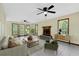 Bright living room with fireplace, tile flooring, ceiling fans and large windows at 202 Woodbridge Dr, Summerville, SC 29486