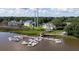 Aerial view of a waterfront property featuring a private boat dock, lush greenery, and beautiful Charleston-style homes at 2329 Tall Sail Dr # 704D, Charleston, SC 29414