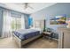 Bright bedroom with blue walls, large window with white curtains, and stylish decor at 2329 Tall Sail Dr # 704D, Charleston, SC 29414