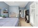 Bedroom featuring soothing blue walls, modern furniture, and natural light at 2329 Tall Sail Dr # 704D, Charleston, SC 29414