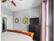 Well-lit bedroom with neutral walls, dark dresser, and ceiling fan at 2329 Tall Sail Dr # 704D, Charleston, SC 29414