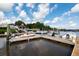 Community boat dock with multiple slips, surrounded by charming homes and beautiful water views beneath a partly cloudy sky at 2329 Tall Sail Dr # 704D, Charleston, SC 29414