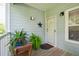 Inviting front porch with plants and seating outside the front door at 2329 Tall Sail Dr # 704D, Charleston, SC 29414