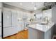Bright kitchen with white cabinets, quartz counters, and stainless-steel appliances at 2329 Tall Sail Dr # 704D, Charleston, SC 29414