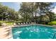 Beautiful pool with lounge chairs, set among tall trees, offers an ideal spot for relaxation and recreation at 2329 Tall Sail Dr # 704D, Charleston, SC 29414