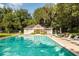 Inviting pool with lounge chairs and lush landscaping provides a relaxing community space at 2329 Tall Sail Dr # 704D, Charleston, SC 29414