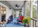 Relaxing porch with blue floors, comfortable chairs, and lush greenery at 2329 Tall Sail Dr # 704D, Charleston, SC 29414