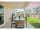 Covered patio features an outdoor dining table with seating, overlooking the well-maintained backyard at 269 Firewheel Ct, Summerville, SC 29486