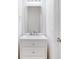 Bright white bathroom features a vanity with drawers and modern fixtures under a large mirror at 282 Swallowtail Ln, Goose Creek, SC 29445