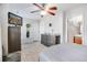 Well-lit bedroom with a ceiling fan, decor, and view into an en suite bathroom at 282 Swallowtail Ln, Goose Creek, SC 29445