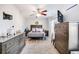 Cozy bedroom featuring a queen bed, ceiling fan and a window overlooking a garden at 282 Swallowtail Ln, Goose Creek, SC 29445