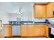 Stylish kitchen featuring wooden cabinets, stainless steel appliances and bar seating at 282 Swallowtail Ln, Goose Creek, SC 29445