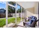 Inviting screened-in patio with wicker chairs and a view of the backyard at 282 Swallowtail Ln, Goose Creek, SC 29445