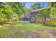 Large, grassy backyard with brick home and screened-in porch at 303 High Grove Rd, Summerville, SC 29485
