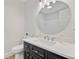 Powder room with elegant black vanity, quartz countertop, round mirror, and white fixtures at 303 High Grove Rd, Summerville, SC 29485