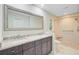 Bright bathroom features a double vanity with stone counters and a large framed mirror at 303 High Grove Rd, Summerville, SC 29485