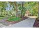 View of home with brick exterior, showing garage, driveway, and landscaped yard at 303 High Grove Rd, Summerville, SC 29485