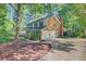 View of home with brick exterior and attached garage, showcasing the driveway and manicured landscaping at 303 High Grove Rd, Summerville, SC 29485