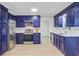 Updated kitchen with stainless steel appliances, white countertops and beautiful modern blue cabinets at 303 High Grove Rd, Summerville, SC 29485