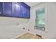 Laundry room with blue cabinets and a bright window with natural light at 303 High Grove Rd, Summerville, SC 29485