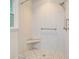 Clean shower features white tile, a corner seat and a handheld sprayer at 303 High Grove Rd, Summerville, SC 29485