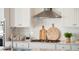 Close-up of kitchen countertop with stainless steel faucet, modern cooktop, and stylish decor at 304 Archar St, Summerville, SC 29486