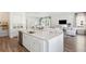 Open-concept kitchen featuring a large island, stainless steel appliances, and abundant natural light at 304 Archar St, Summerville, SC 29486