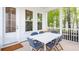 Inviting screened porch with a white dining table and seating, perfect for outdoor dining and relaxation at 304 Archar St, Summerville, SC 29486
