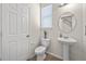 Half bathroom with pedestal sink, oval mirror, and tile floors at 316 Beachgrass Ln, Summerville, SC 29486